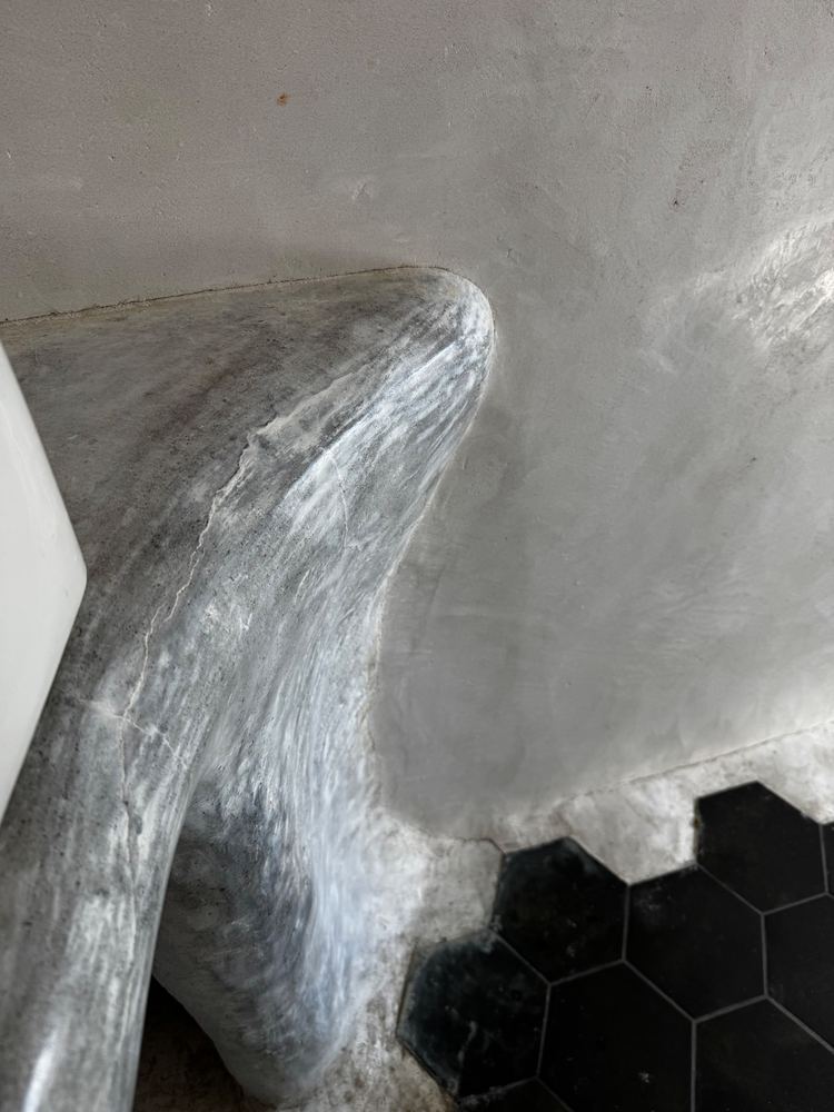 Sculpted plaster bathroom vanity at The Tavern
