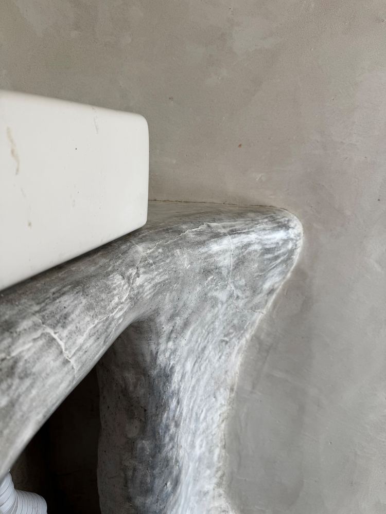 Sculpted plaster bathroom vanity at The Tavern