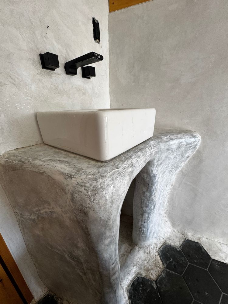 Sculpted plaster bathroom vanity at The Tavern