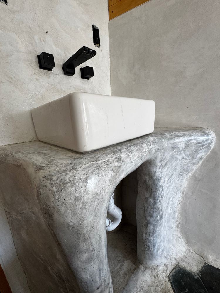 Sculpted plaster bathroom vanity at The Tavern
