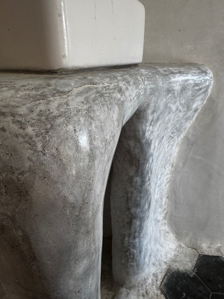 Sculpted plaster bathroom vanity at The Tavern